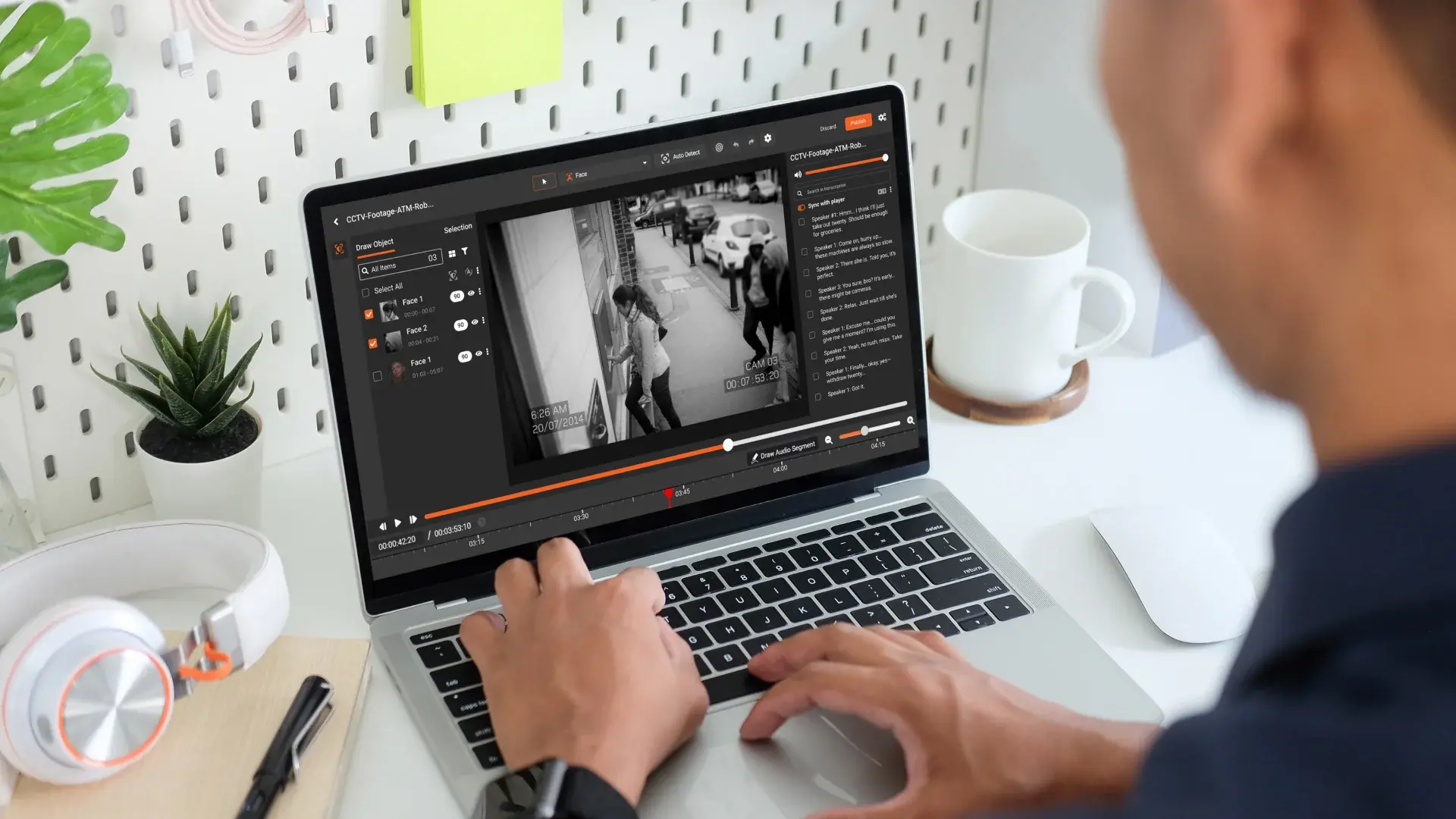 A person reviewing CCTV footage to redact PII.