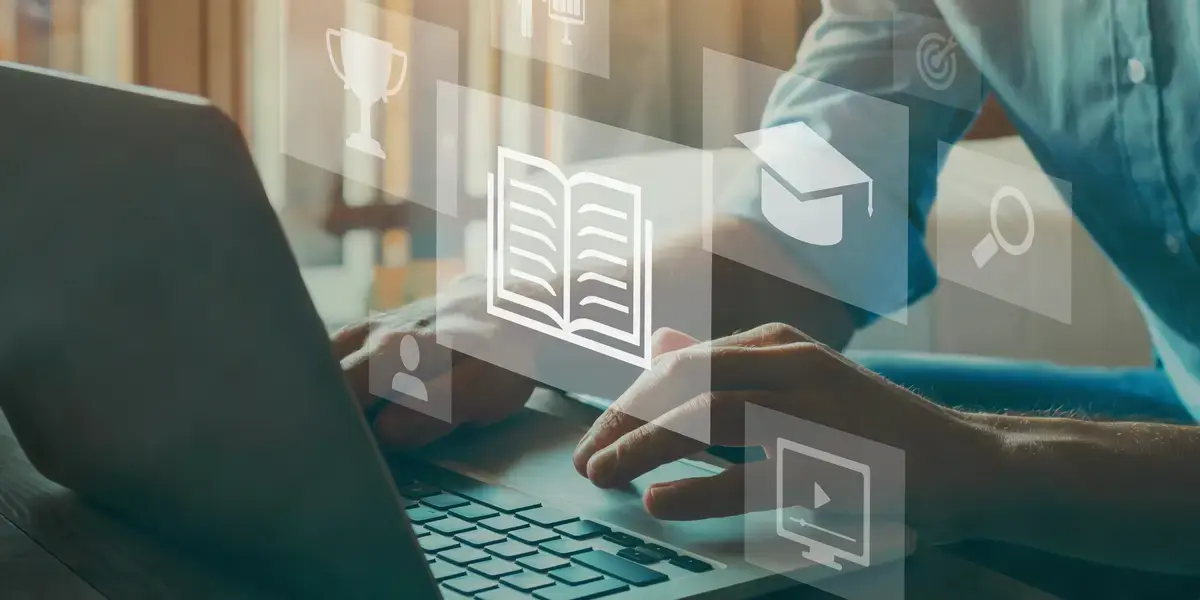 A laptop with floating icons for documents, images and video
