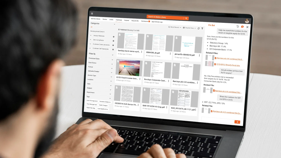 A laptop showing a grid of scanned document pages