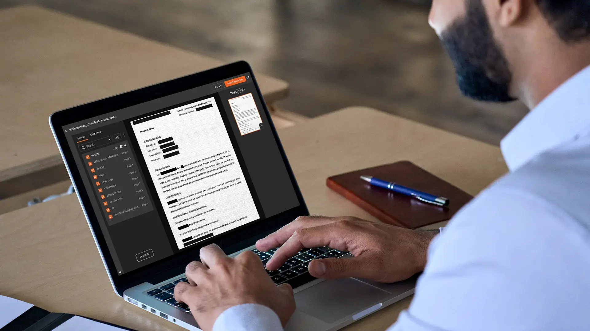 a person redacting documents staying HIPAA Complaint